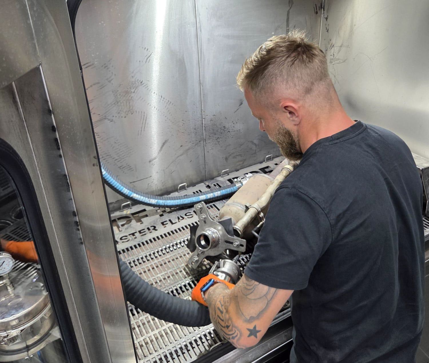 Technician cleaning a diesel particulate filter